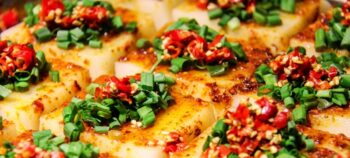 Seidetofublöcke mariniert mit kleingeschnittenen roten Chillies und grünem Schnittlauch.